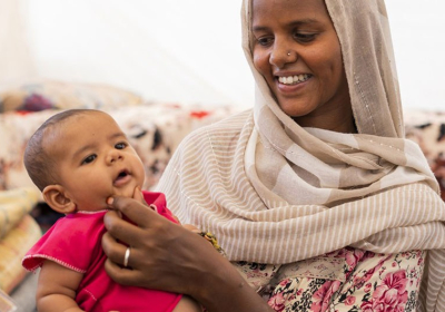 An Ethiopian mother and her child live with six other family members in a small hut at the Um Rakuba Refugee camp in eastern Sudan.